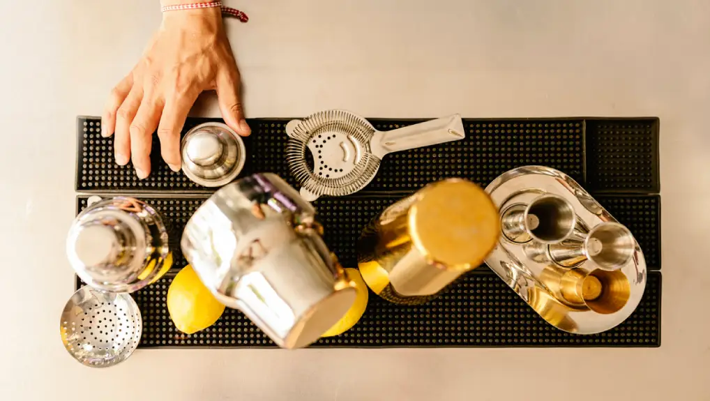 image of a collection of bar equipment overhead shot with a plane view of a selection of cocktail and drink service tools.