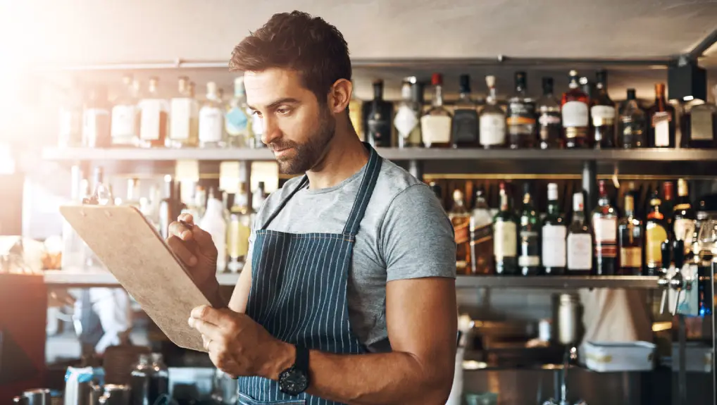 Image of bartender carrying out daily maintenance tasks for bar equipment.