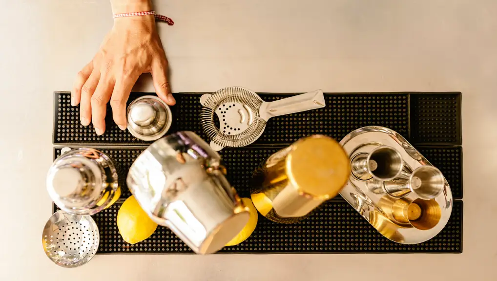 image of a collection of bar equipment overhead shot with a plane view of a selection of cocktail and drink service tools.