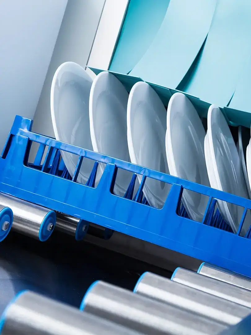 Close up image of plates stacked in a plate washer