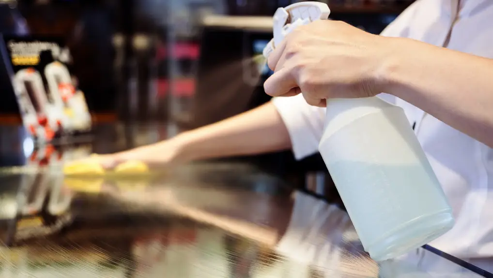 close up image of cleaning tasks being carried out in a bar.