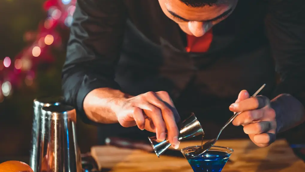 Close up image of a bartender creating a precision and consistency of cocktail making