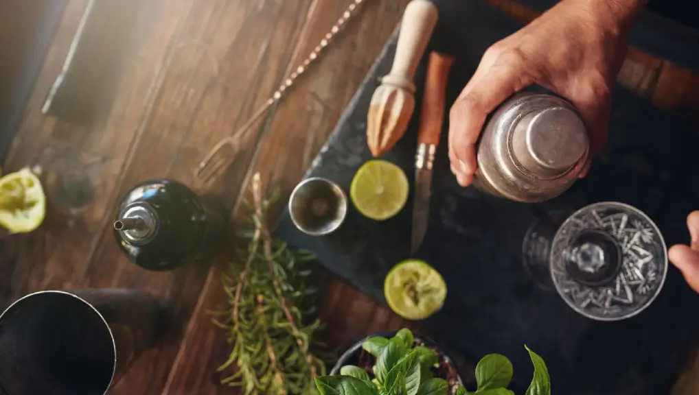 Close up image of a bartender creating a drink after learning to build the perfect cocktail kit